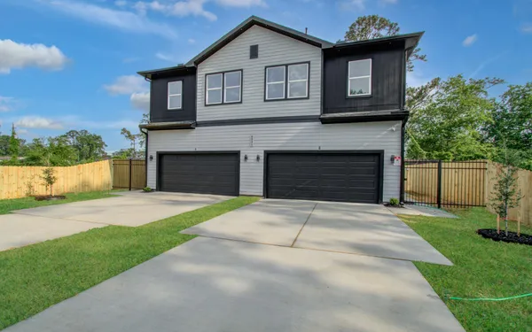 a front view of a house with a garden and a yard