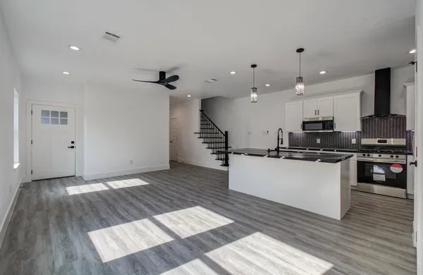 a view of kitchen with sink microwave and stove