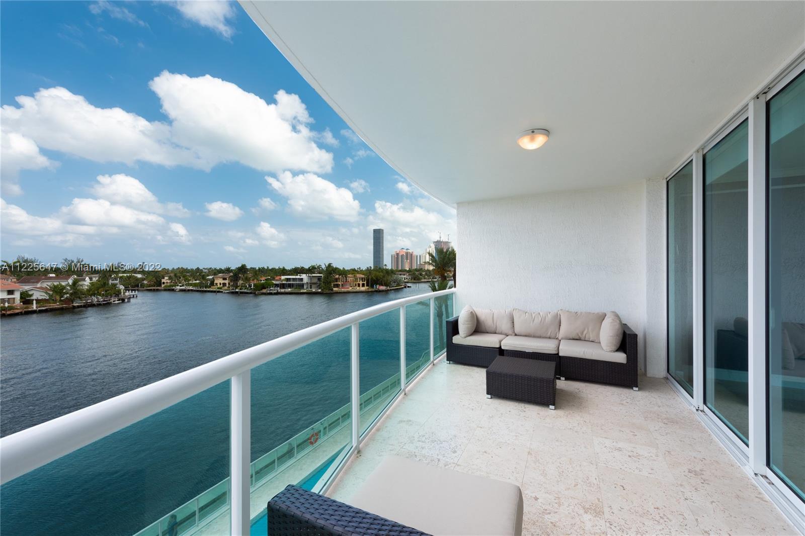 a balcony with seating space and lake view