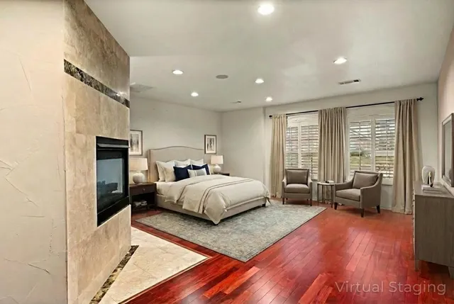 a spacious bedroom with a bed and wooden floor