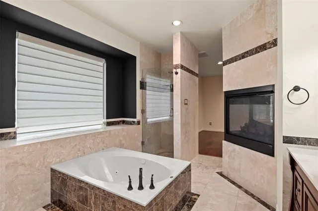 a bathroom with a bathtub and a shower