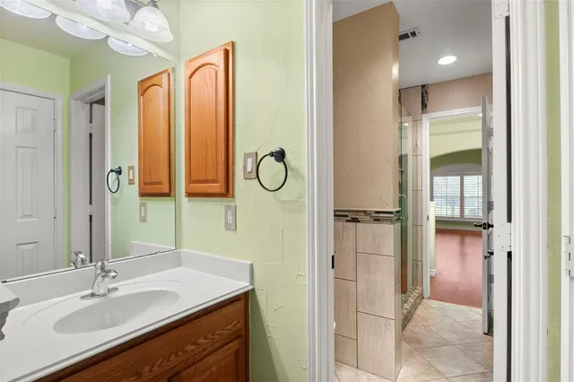 a bathroom with a double vanity sink mirror and shower