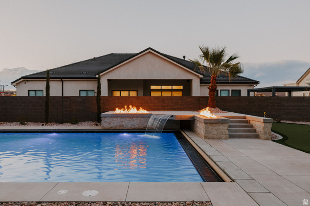 2281 South Crimson Cliffs Way St. George, UT 84790 - Photo 7 of 47 View of pool featuring a fire pit, patio surround, and a fenced backyard