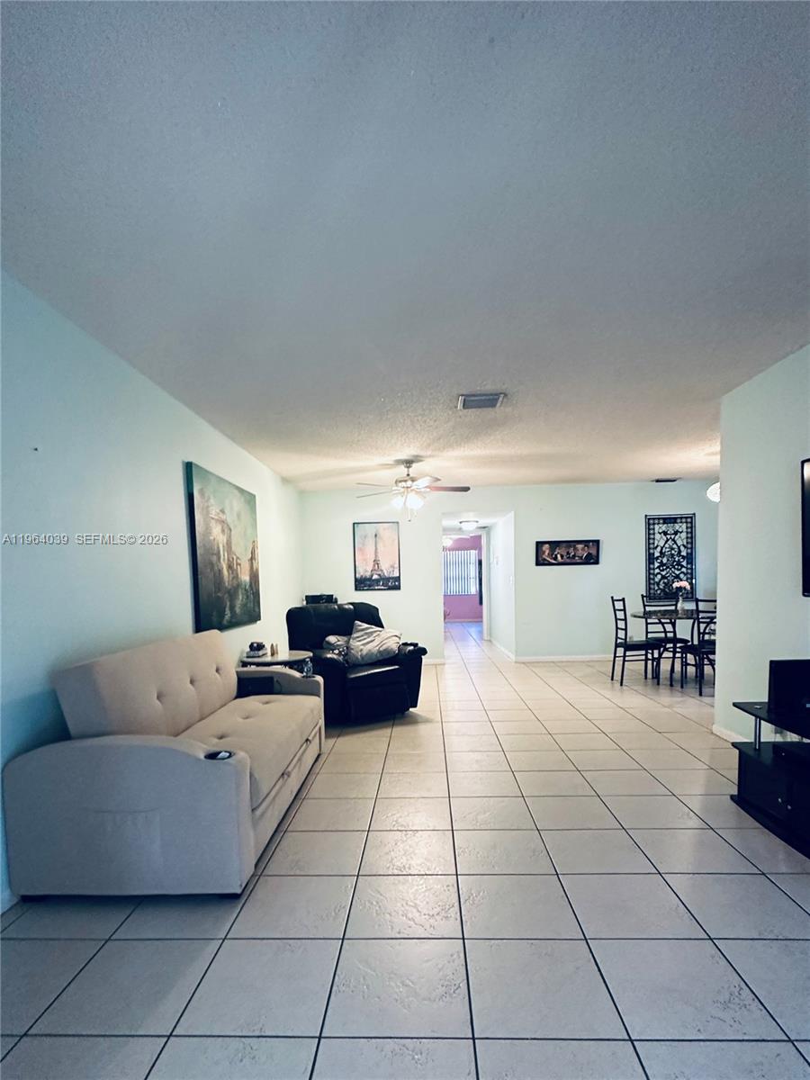 5260 Nesting Way, Unit B Delray Beach, FL 33484 - Photo 2 of 9 a living room with furniture and a table