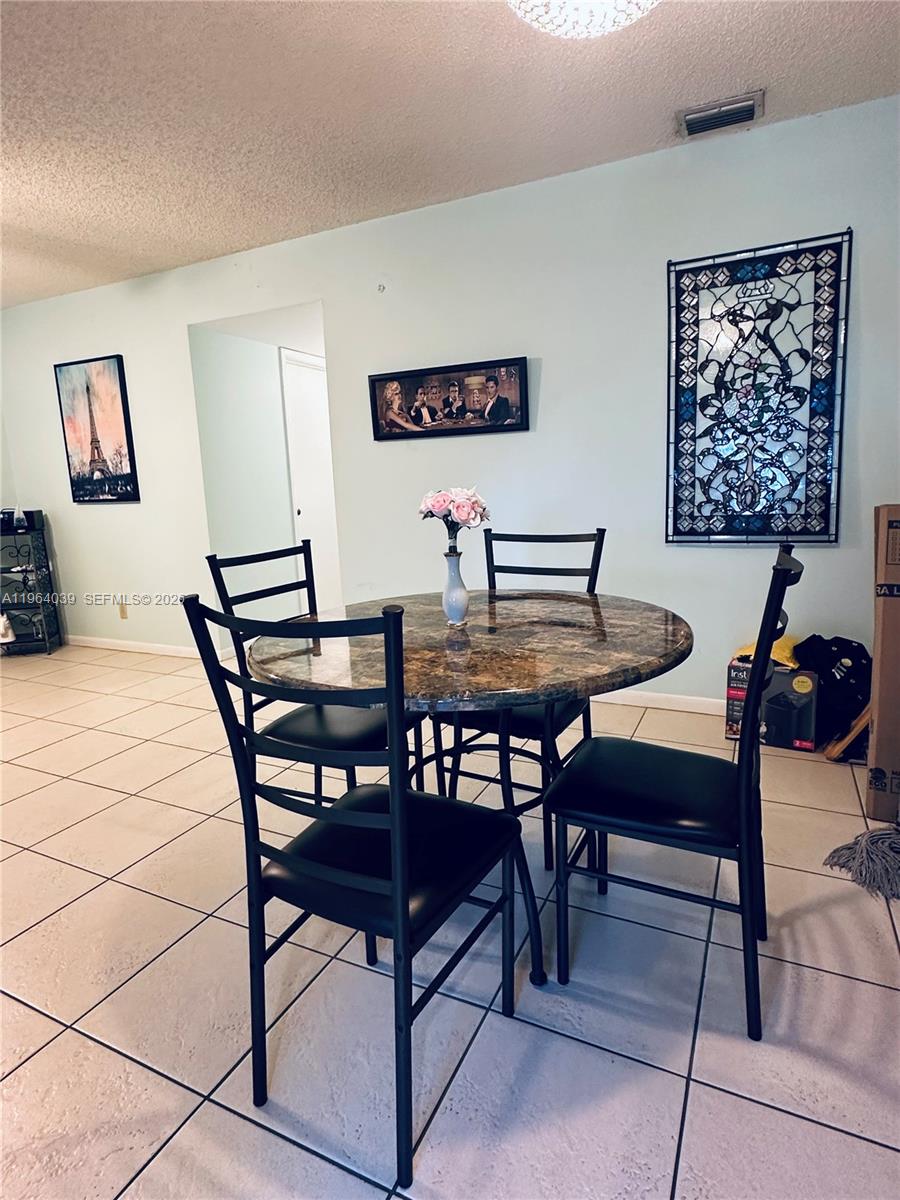 5260 Nesting Way, Unit B Delray Beach, FL 33484 - Photo 4 of 9 a view of a dining room with furniture