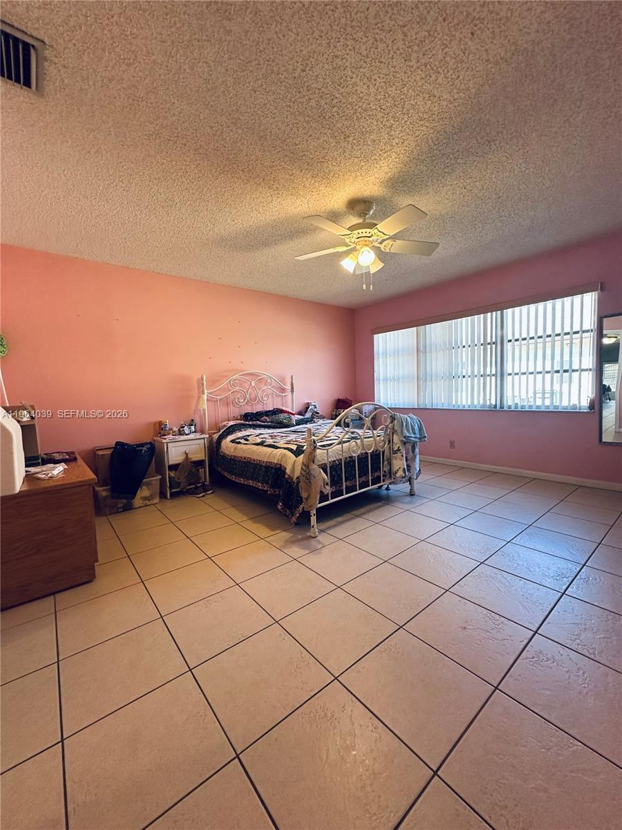 5260 Nesting Way, Unit B Delray Beach, FL 33484 - Photo 8 of 9 a living room with couches and chandelier