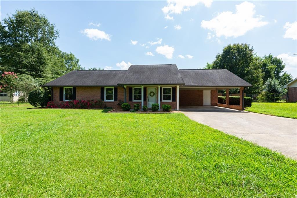 1158 Fairview Road Northwest Calhoun, GA 30701 - Photo 1 of 1 a front view of a house with a garden