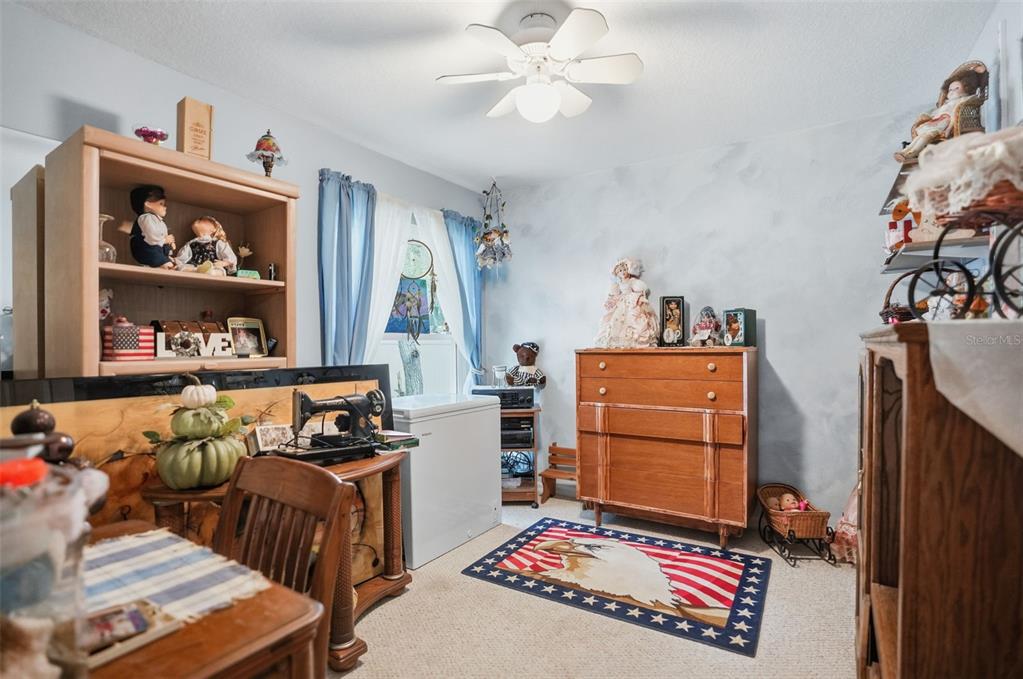 204 Planter Road Spring Hill, FL 34606 - Photo 18 of 45 a living room with furniture and a baby crib