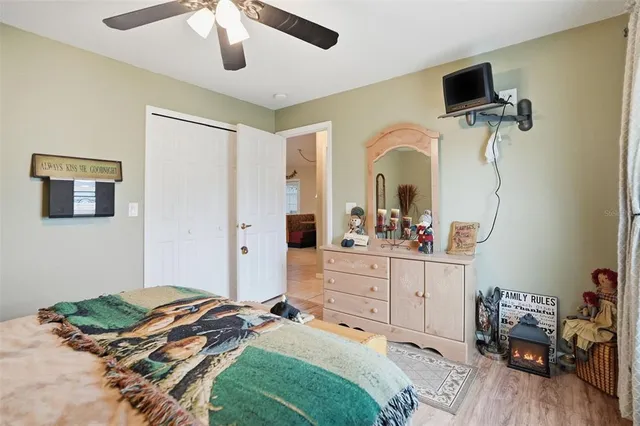 a bedroom with a bed and a mirror on the dresser