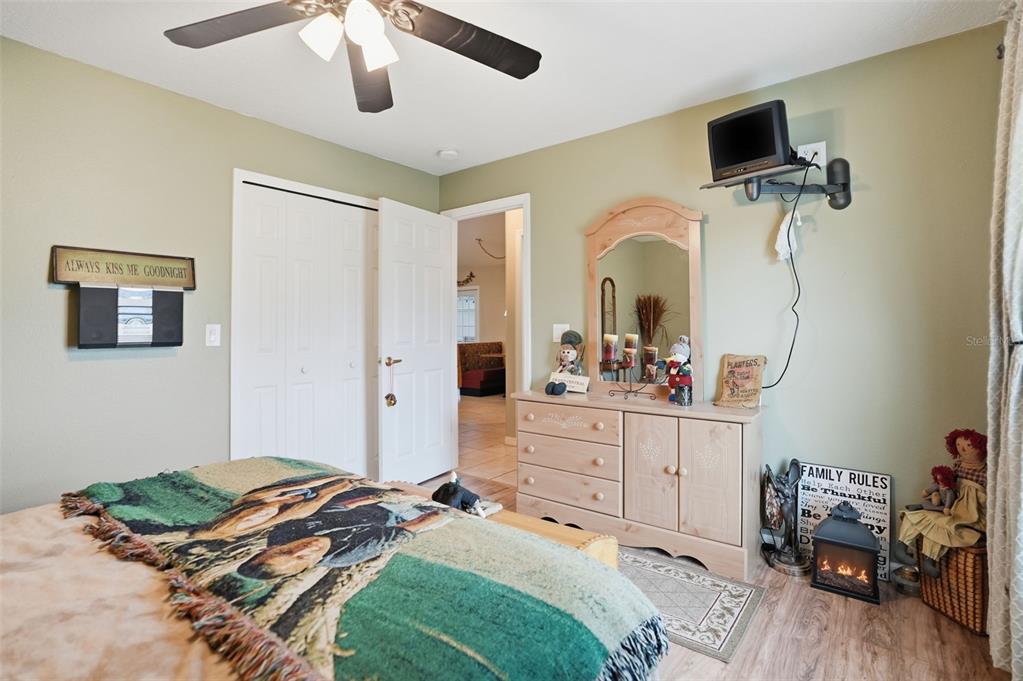 204 Planter Road Spring Hill, FL 34606 - Photo 21 of 45 a bedroom with a bed and a mirror on the dresser