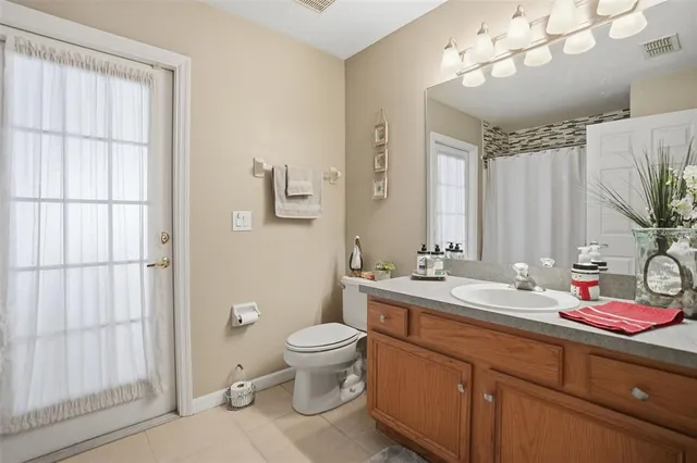 a bathroom with a double vanity sink mirror and toilet