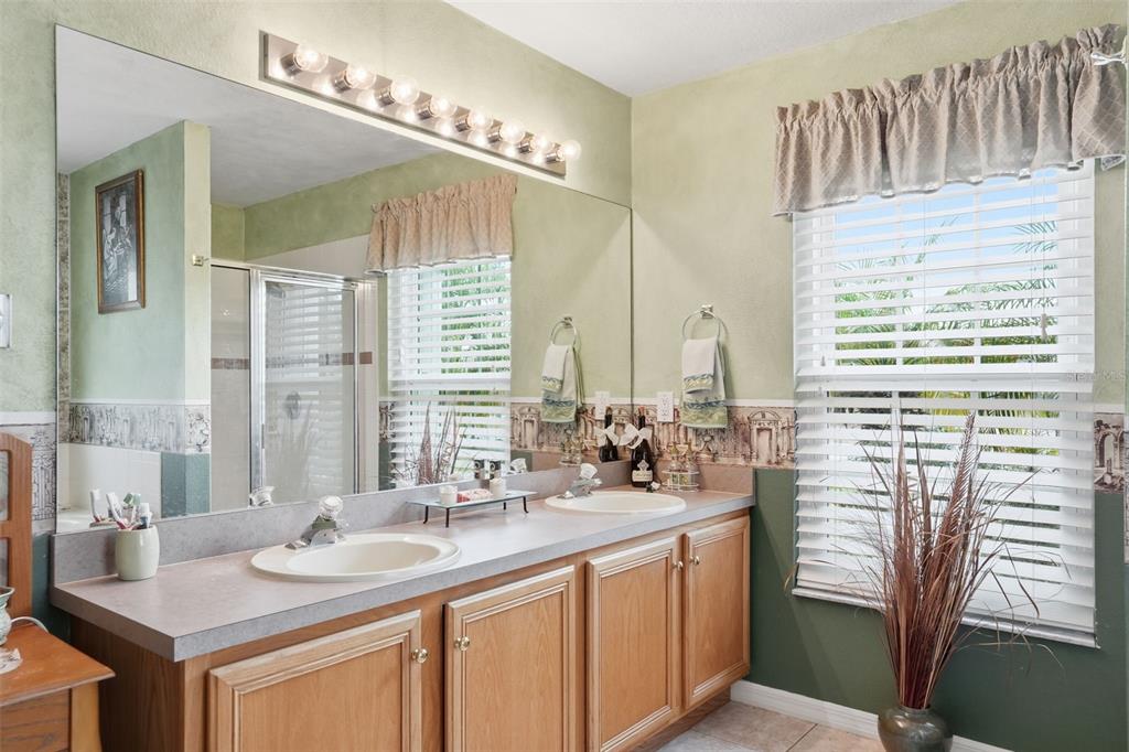 204 Planter Road Spring Hill, FL 34606 - Photo 29 of 45 a bathroom with double vanity and a mirror