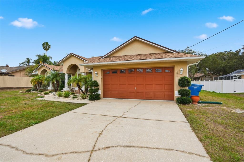 204 Planter Road Spring Hill, FL 34606 - Photo 3 of 45 a front view of a house with a yard