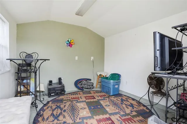 a bedroom with furniture and a window