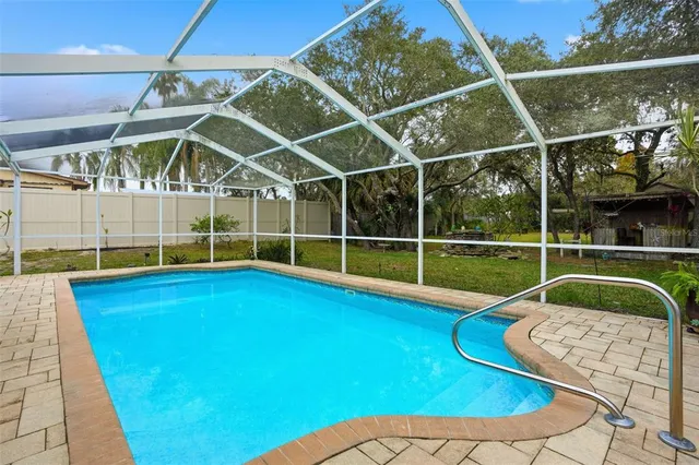 a view of a backyard with swimming pool
