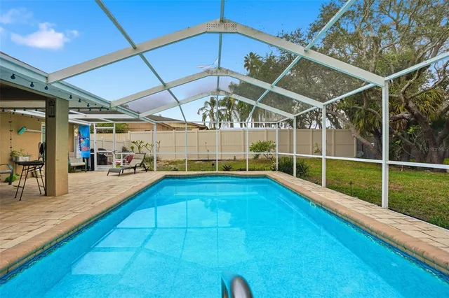a view of a backyard with swimming pool