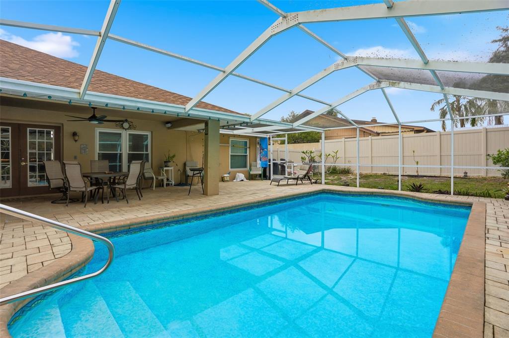 204 Planter Road Spring Hill, FL 34606 - Photo 35 of 45 a view of a patio with table and chairs under an umbrella