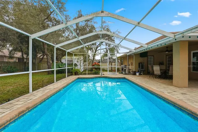 a view of a backyard with a swimming pool