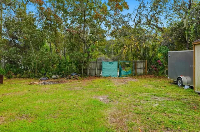 a backyard of a house with yard and trampoline