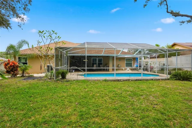 a view of a house with a backyard porch and sitting area