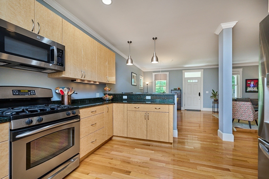 25 Union Street, Unit 2 Northampton, MA 01060 - Photo 15 of 38 a kitchen with stainless steel appliances granite countertop a stove cabinets and microwave
