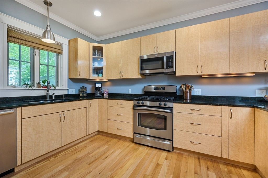 25 Union Street, Unit 2 Northampton, MA 01060 - Photo 16 of 38 a kitchen with stainless steel appliances granite countertop a stove a sink and white cabinets