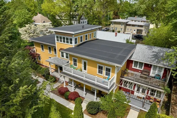 an aerial view of a house with a yard
