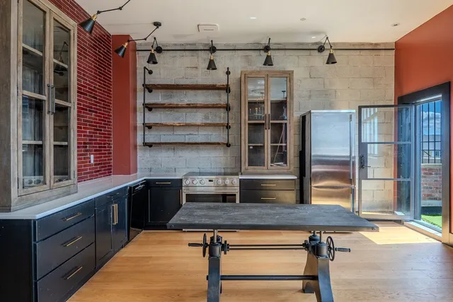 a kitchen with stainless steel appliances granite countertop a stove and a refrigerator