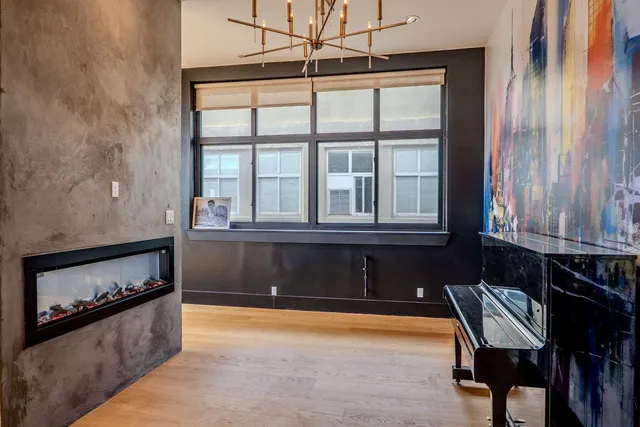 a living room with stainless steel appliances kitchen island granite countertop furniture a rug and a kitchen view