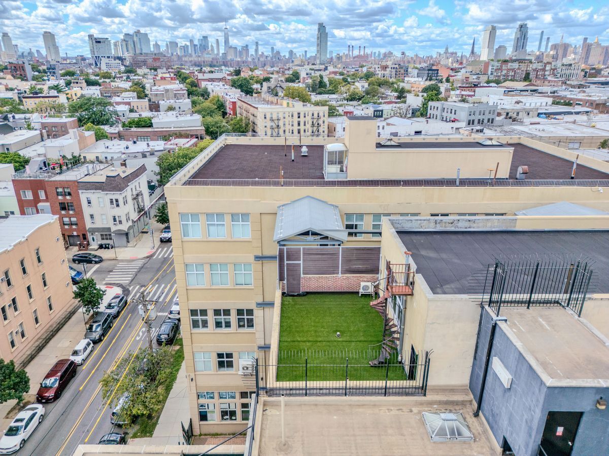 231 Norman Avenue, Unit 511 Brooklyn, NY 11222 - Photo 4 of 30 an aerial view of a house with a garden and lake view