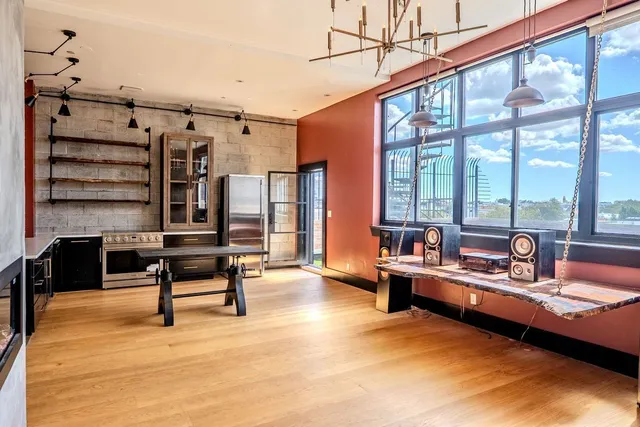 a bedroom with furniture and a large window