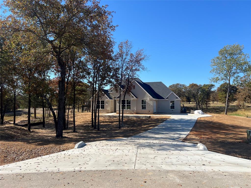 1053 Llano Way Poolville, TX 76487 - Photo 1 of 26 a front view of a house with a yard