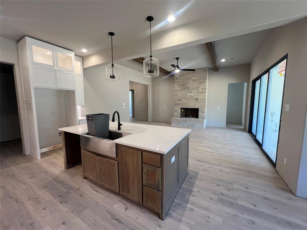 1053 Llano Way Poolville, TX 76487 - Photo 15 of 26 a view of kitchen with sink microwave and refrigerator