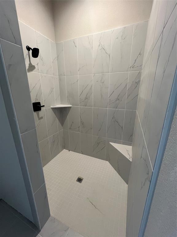 1053 Llano Way Poolville, TX 76487 - Photo 19 of 26 a bathroom with a granite countertop shower