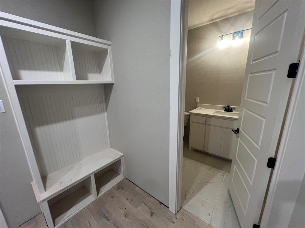 1053 Llano Way Poolville, TX 76487 - Photo 22 of 26 a utility room with a sink a washer and dryer