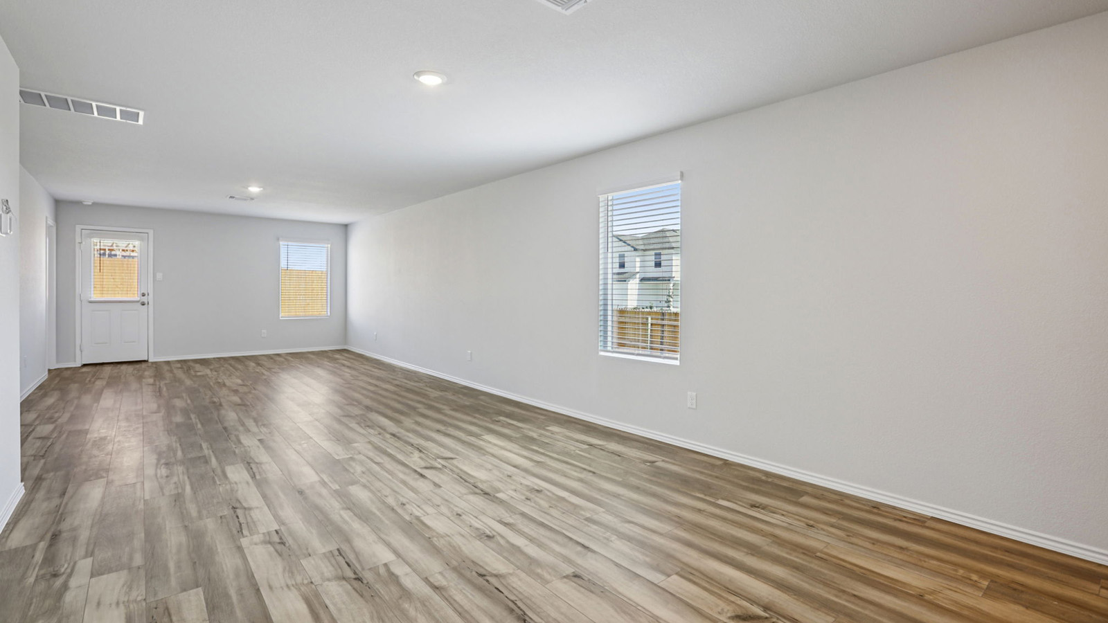 156 Wyatt Way Jarrell, TX 76537 - Photo 10 of 30 Spacious interior room featuring wood-finish flooring, recessed lighting, and light-toned wall paint