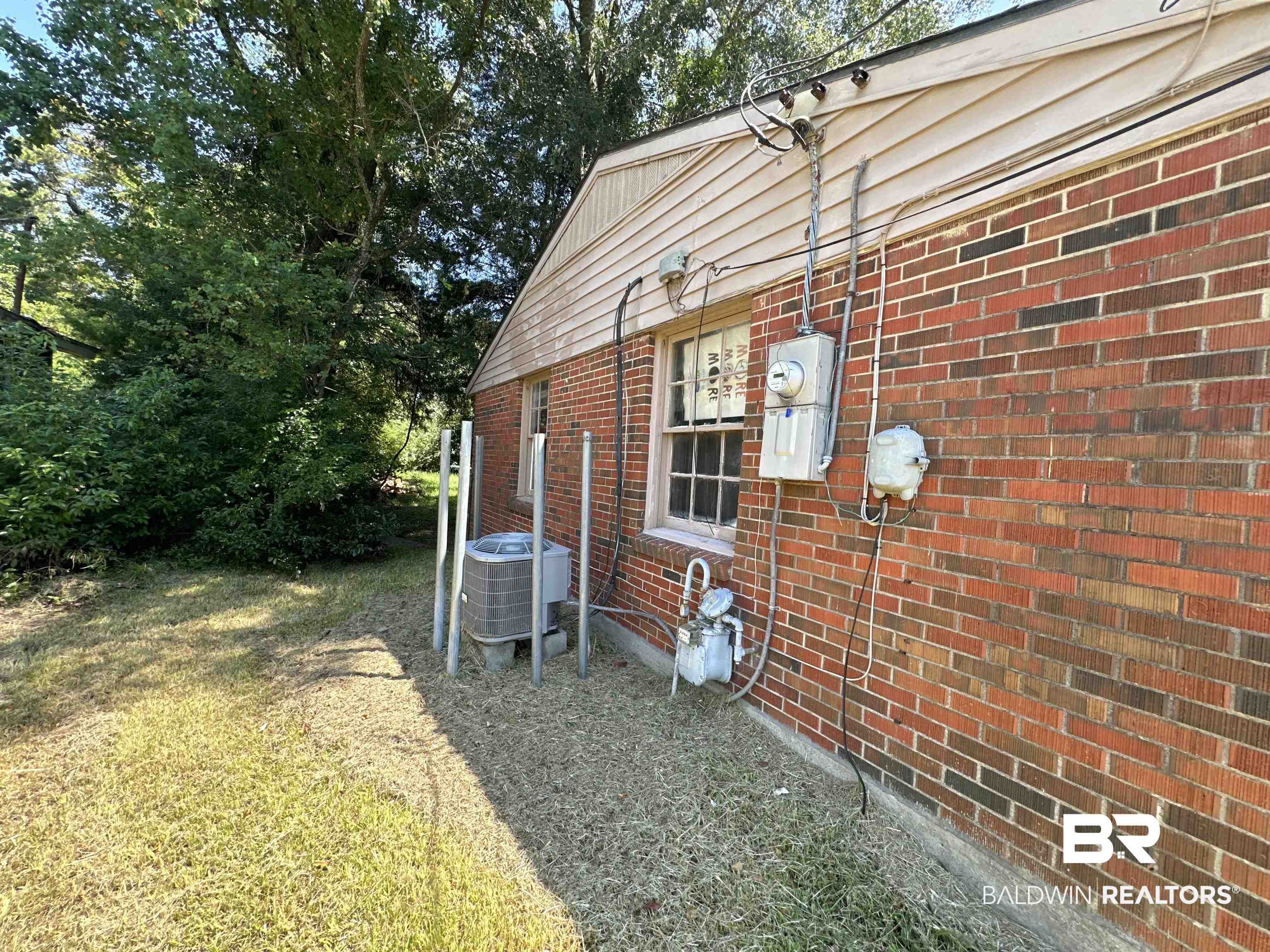 58 Chieftain Way Mobile, AL 36611 - Photo 7 of 12 View of property exterior featuring central air condition unit