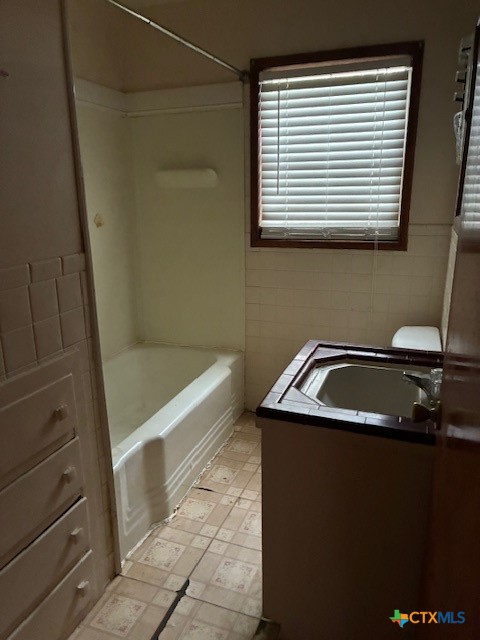 209 Highland Street Yoakum, TX 77995 - Photo 8 of 10 a bathroom with a sink and a bathtub