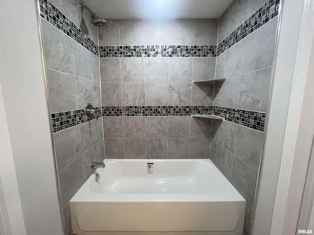 a bathroom with a shower and a bathtub