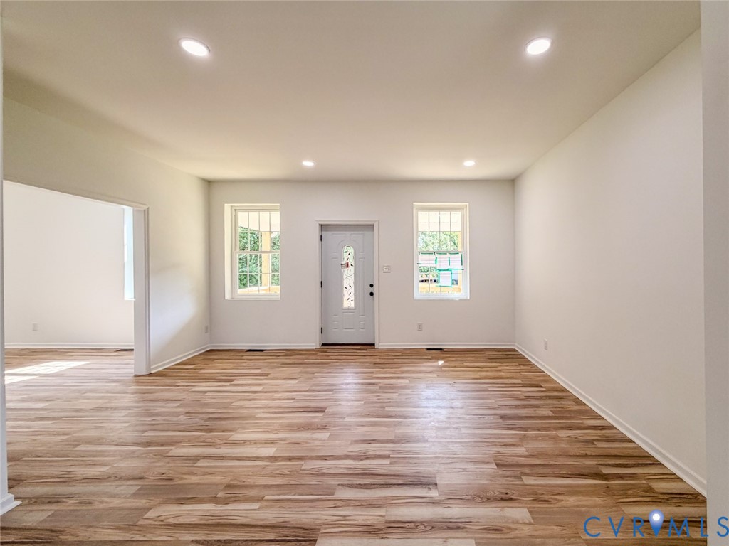 19614 Manson Church Road McKenney, VA 23872 - Photo 8 of 24 an empty room with wooden floor and windows