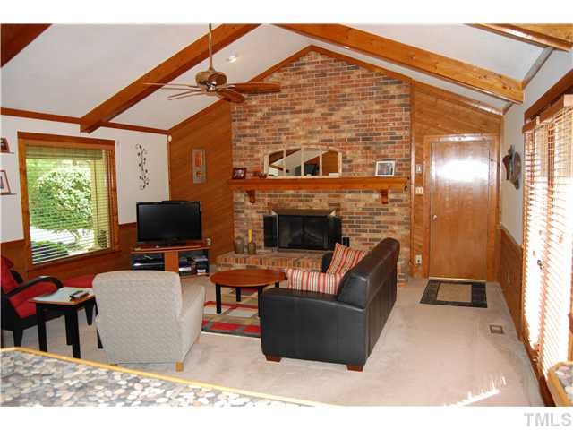 308 Baytree Lane Raleigh, NC 27615 - Photo 17 of 17 Fantastic family room with cathedral ceiling and masonry fireplace with raised hearth! Doors to deck and open floorplan to kitchen!