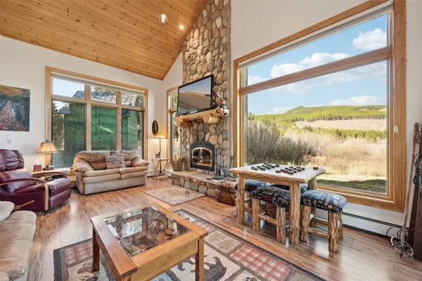 a living room with furniture a large window and a table