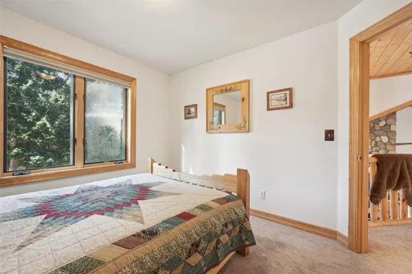 a bedroom with a bed and a large window