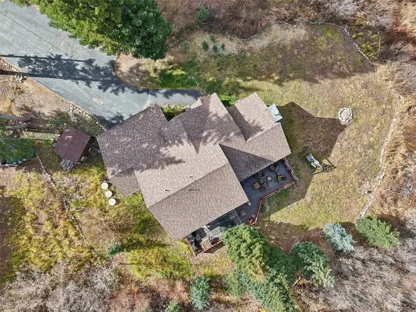 an aerial view of a house with a yard and lake view