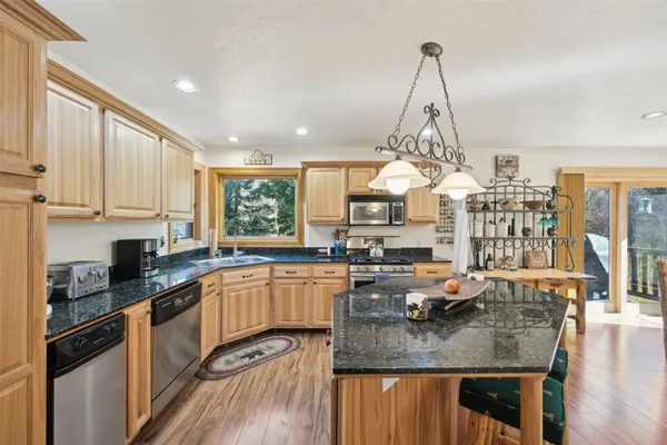 a kitchen with counter top space cabinets and appliances