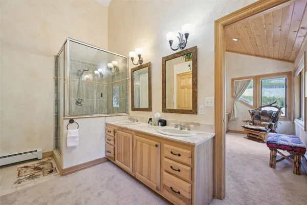 a spacious bathroom with a double vanity sink and a mirror