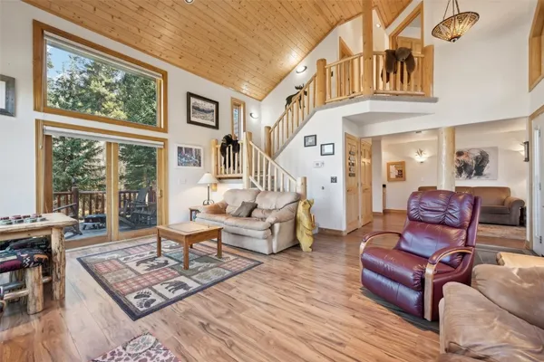 a living room with furniture a rug and a large window
