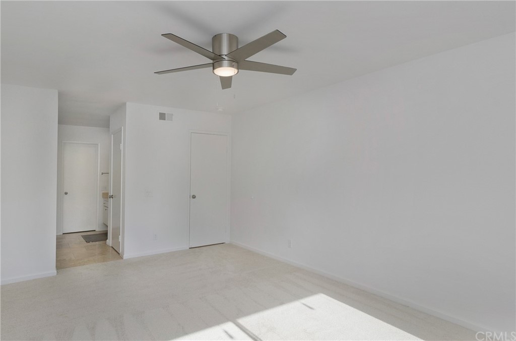17241 Candleberry Irvine, CA 92612 - Photo 16 of 24 an empty room with a ceiling fan and a window