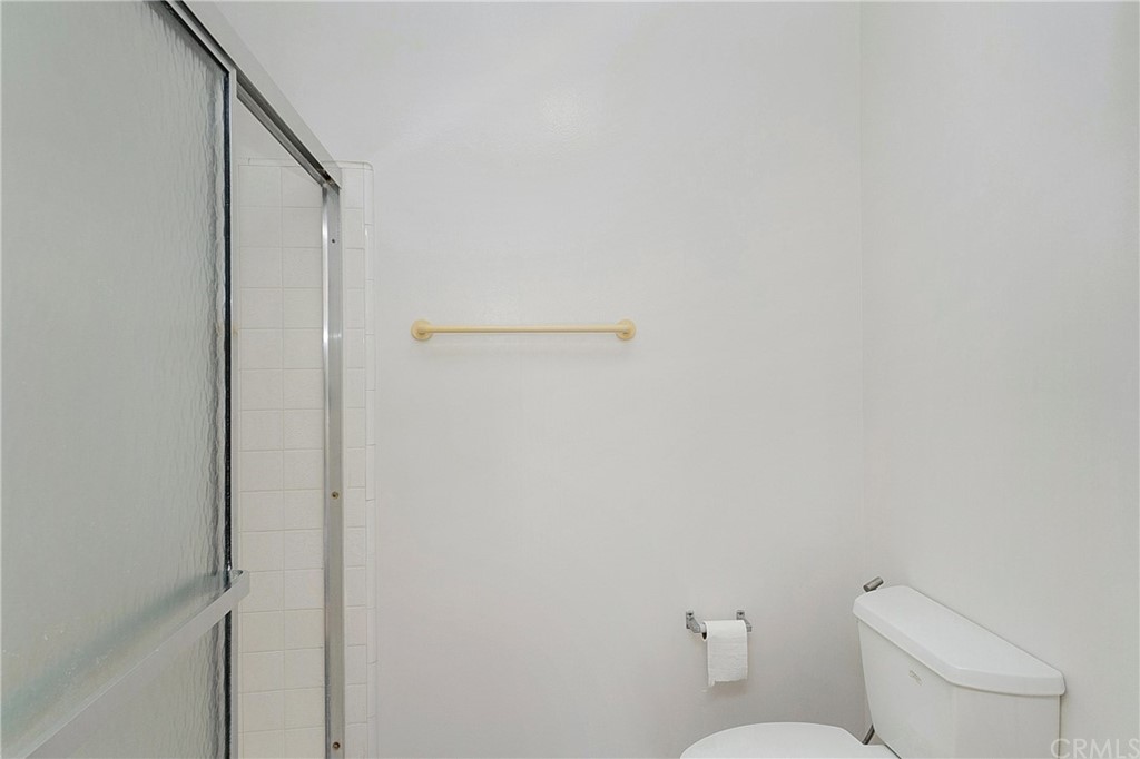 17241 Candleberry Irvine, CA 92612 - Photo 17 of 24 a white toilet sitting next to a shower