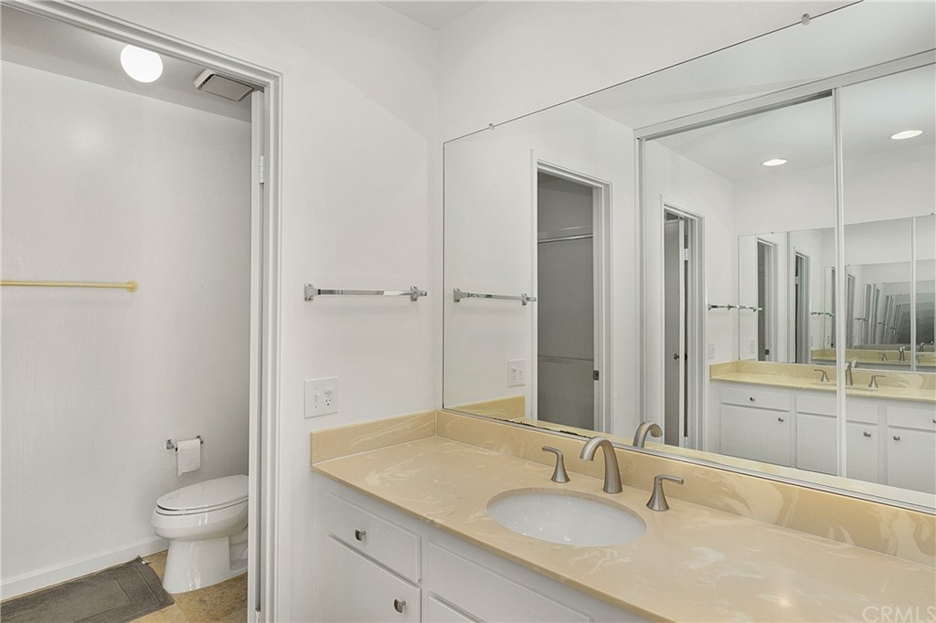 17241 Candleberry Irvine, CA 92612 - Photo 18 of 24 a bathroom with a sink and a mirror with toilet